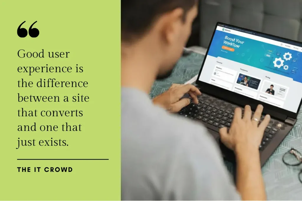 A business professional viewed from behind, typing on a laptop while reviewing a website on screen.