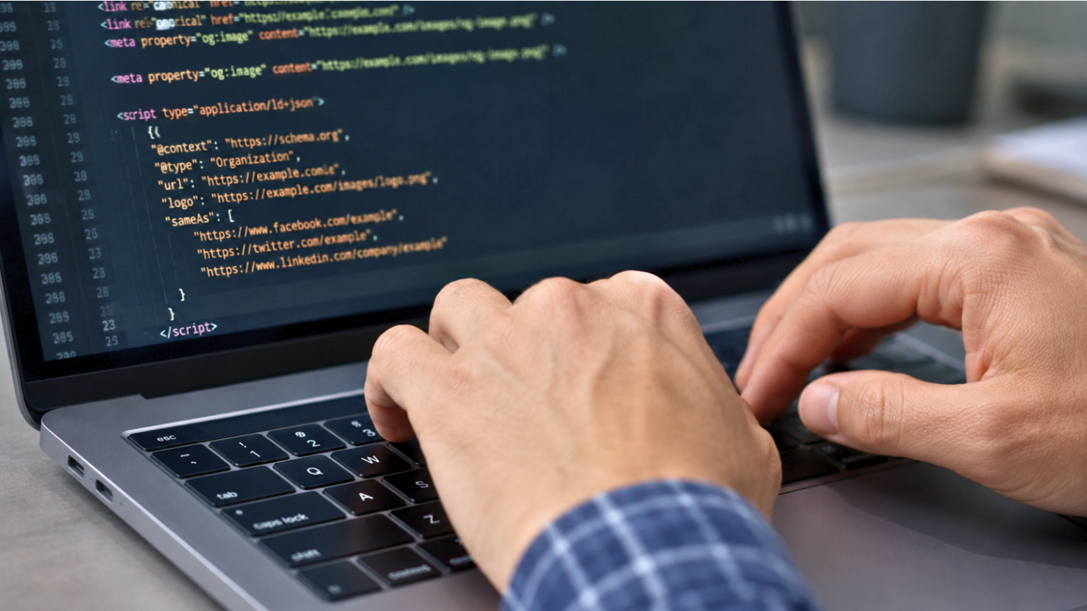 Close-up of hands coding JSON-LD schema markup, a key item on any technical SEO checklist for website structured data.